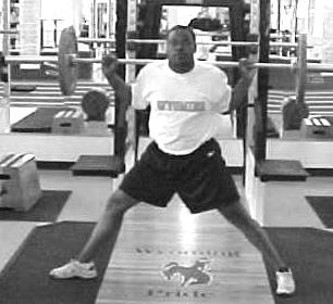 Keeping the chest up, lower the hips until the top of the thighs are parallel with the floor