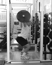 Grip the bar as one would when performing a squat with the bar resting on your shoulders.