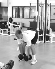 Rear Raise Start with feet shoulder width apart, knees slightly bent, holding a dumbbell in each hand. Maintaining a flat back, bend over at the waist so the chest is parallel with the floor.