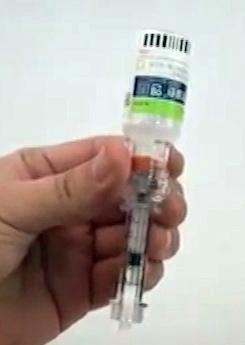 Attach the syringe (filled with air) to the adapter turn syringe clockwise to lock in.