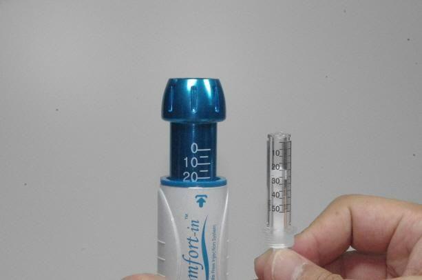 Separate the Syringe from the Adaptor by unscrewing counterclockwise. The Filling Adaptor may be used to fill several Syringes from a multi dose vial.