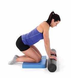 Lean back and slightly toward one side, using your arms for stabilization, then roll yourself back and forth over the foam roller.