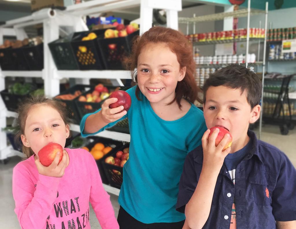 Local children enjoy apples in Food for People s Choice Pantry in Eureka.