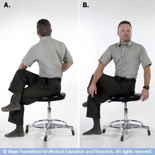 Sit on an armless chair or stool. B. Cross your right leg over your left leg.