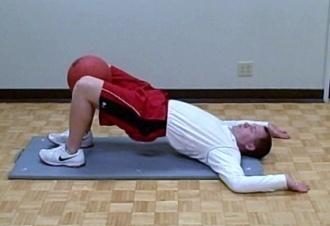 Bridge (Ball squeeze) Coaching Tips: Lie on your back with your feet flat on the floor.