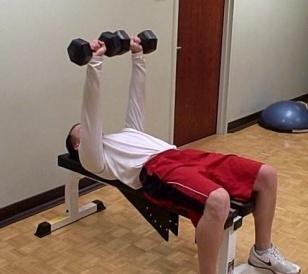 Slowly lie on the bench bringing the dumbbells straight up at chest level.