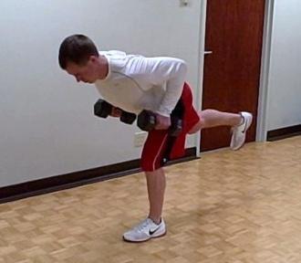Assume a staggered stance with one foot in front of the other, find your balance and lift the back leg up off the floor.