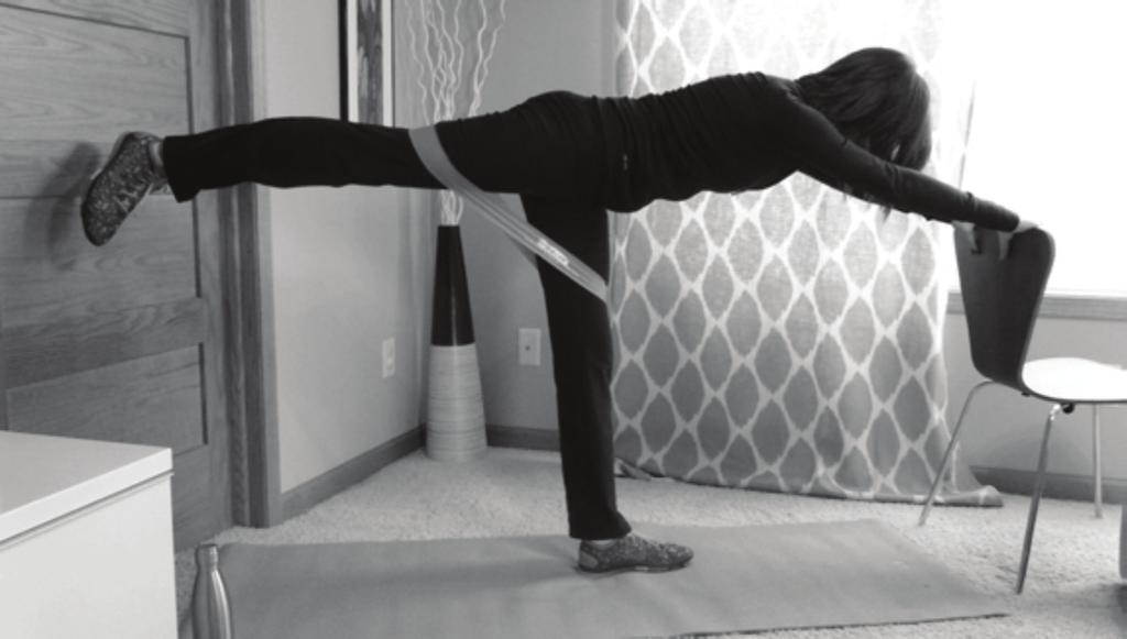 2. Straight Leg Stand with the your feet hip width apart. Place the Cayman Fitness Loop band around your thighs.