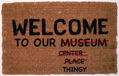 Image: doormat reading: WELCOME TO OUR (scratched