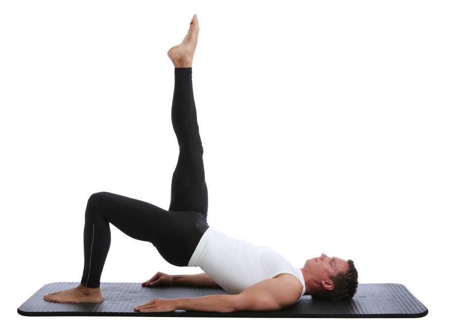 Pressing through the heel of the foot on the ground as you exhale tuck the bottom under and peel the vertebrae one at a time slowly off the floor until the shoulders hips and knees are in