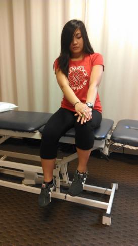 The patient returns to starting position while keeping abdominals contracted and low back flat on the table.