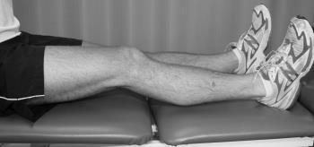 While keeping the knee straight, slowly lower the heel of the affected leg until a