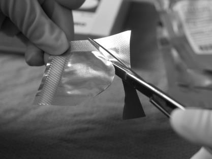 Figure 4: To open the inner pouch, gently hold the crimped edge and cut in an arc-like fashion around the wafer.