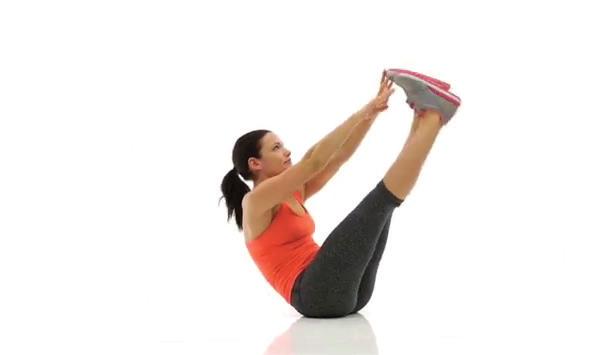 Raise your legs straight up while also lifting your upper body off the floor and reach your