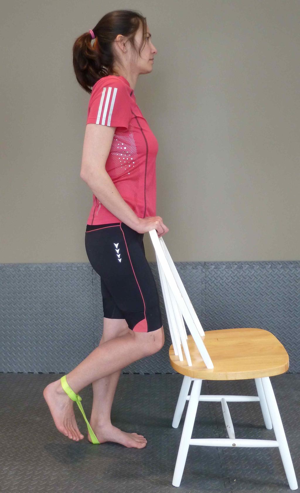 Have a resistance band secured at ground level and looped around your ankle.