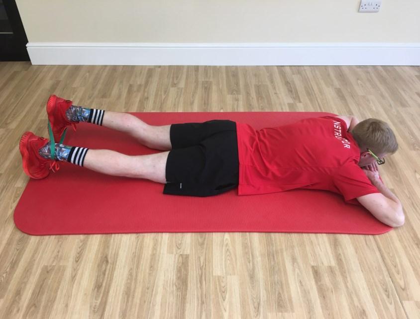 Hamstring Curl Holding (Isometric) - hamstring activation and strengthening exercise Lie on your front (stomach), place the band around one foot and around the opposite ankle.