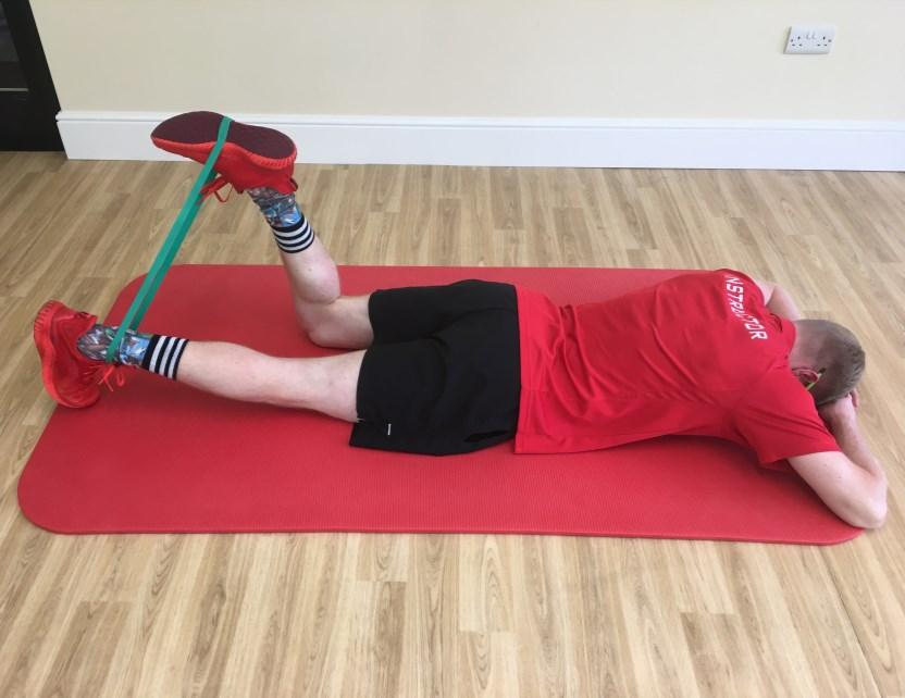 Keep the working leg in the air and lower the anchor leg to the ground. Try to hold this position for 10-30 seconds. Avoid arching lower back, if needed place a pillow below the hips.