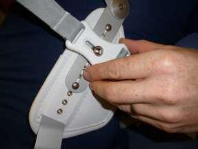 Pull the strap through and hook the white clip onto