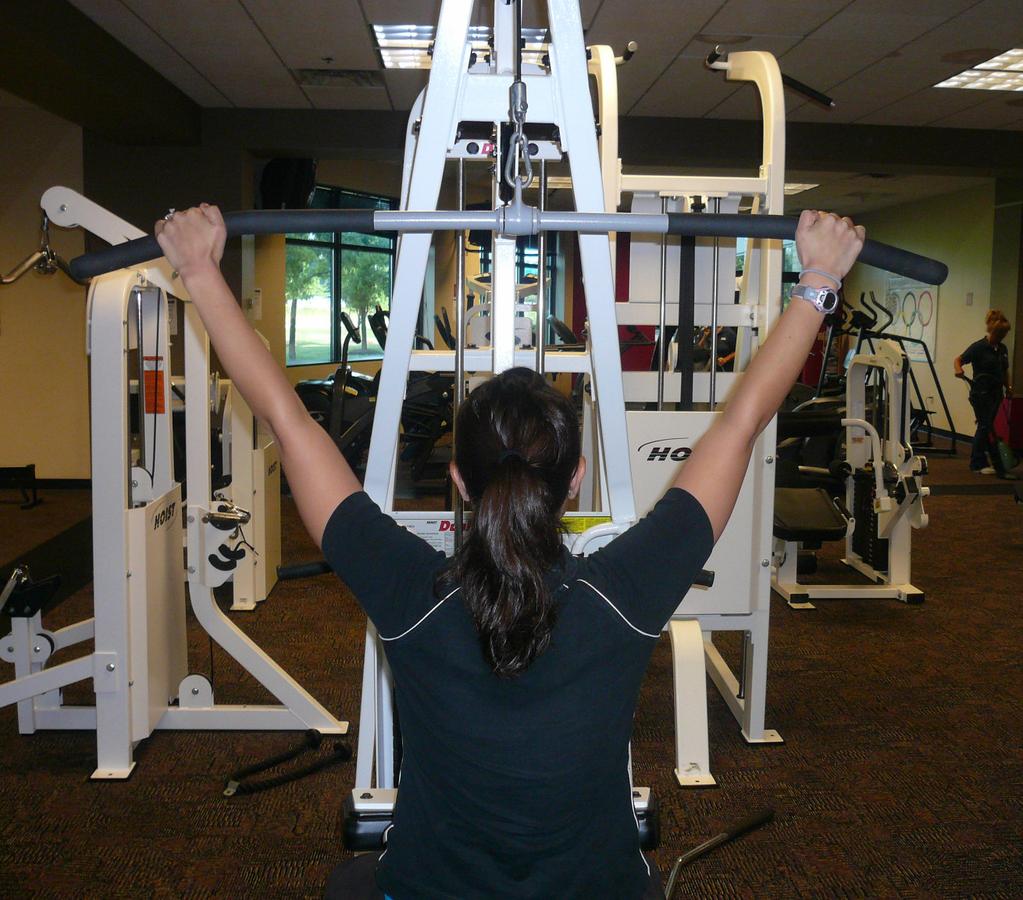 Boxing BRONZE Round 2: Upper Body Exercises Lat Pulldown Machine: Begin by sitting on the machine, facing the weight plates.
