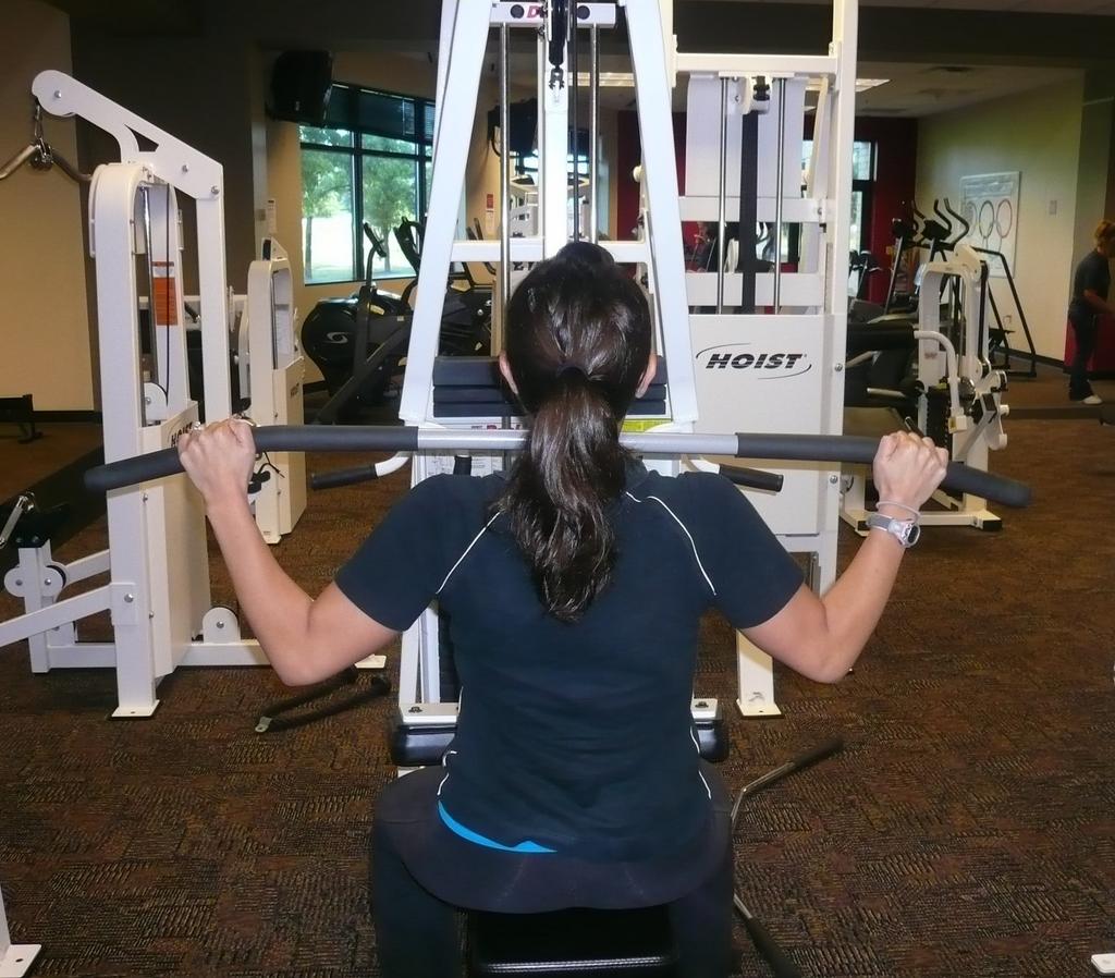 Pull the bar down in front of you down to your chest and slowly return to starting position. Repeat.