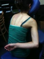 NEXT, ASK CLIENT TO PUT THEIR ARM BEHIND THEIR BACK WITH BACK OF HAND AND WRIST ANGLED TOWARD THE LOWER BACK. ASK THEM TO MOVE THE ELBOW FORWARD (THIS SHOULD ALLOW THE SCAPULA TO WING UP ).