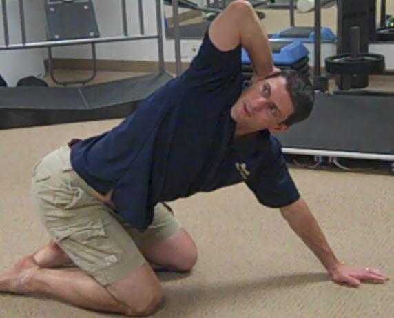 4 Point Thoracic Rotation sit back on your heels to lock out the lower back.