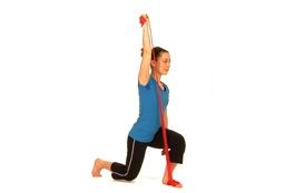 The opposite hand holds firmly the elastic. Lower straight down creating a 90 degrees angle at the knee and hip.