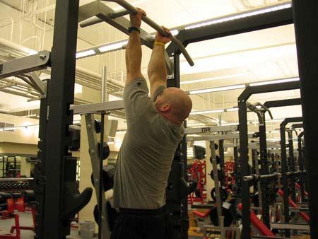 Pick up the dumbbells, then retract and depress your shoulder blades so you re