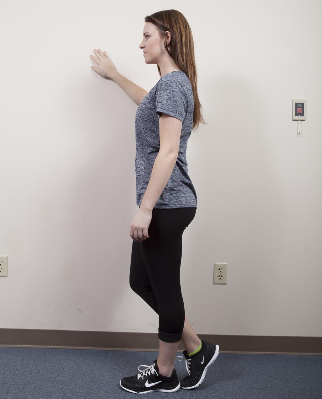 Tandem walk: Stand sideways next to a wall for support. Place one hand on the wall for support if needed. Keep your stomach muscles tight and your chin tucked in.