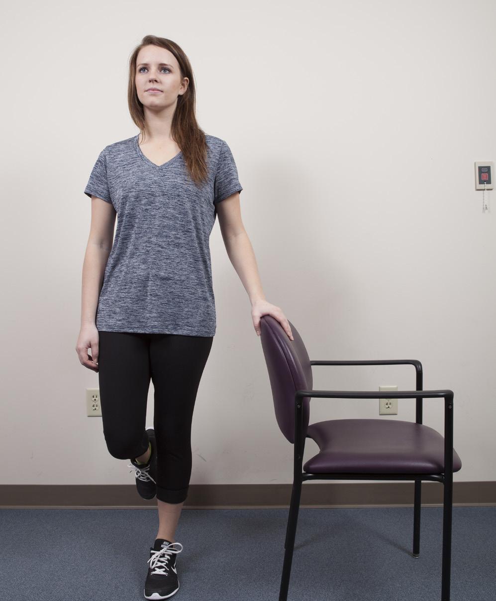 Balance at the chair: Practice balancing on one leg. Stand straight and tall. Support yourself by holding onto the backs of 2 steady chairs or a counter. Do not bend at your waist or knees.