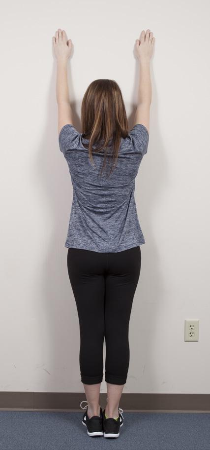 Wall Arch: This exercise will stretch your shoulders and calves and tone your back and stomach muscles. Stand facing the wall with your arms at your sides.