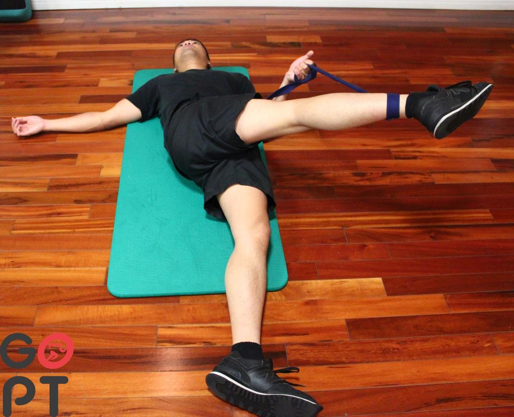 ITB stretch with belt Try to keep your back/hip on the ground, bringing just the leg across your body with a straight