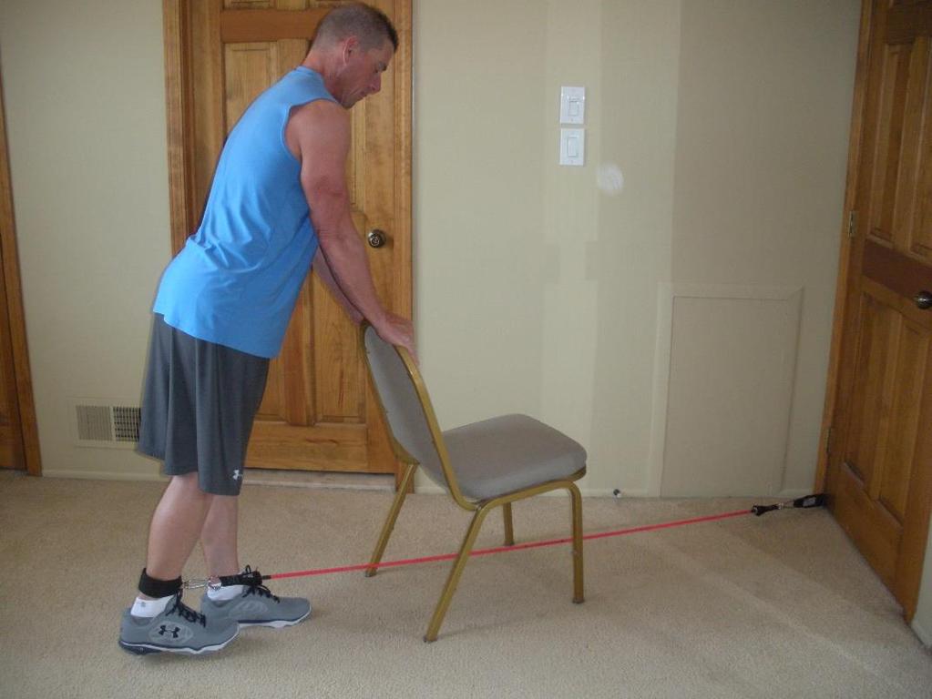 Glute Kickback Use a stable chair for balance Turn chair around as shown Keep working foot slightly off the ground Knee locked on the leg being exercised Push heel as far back as possible