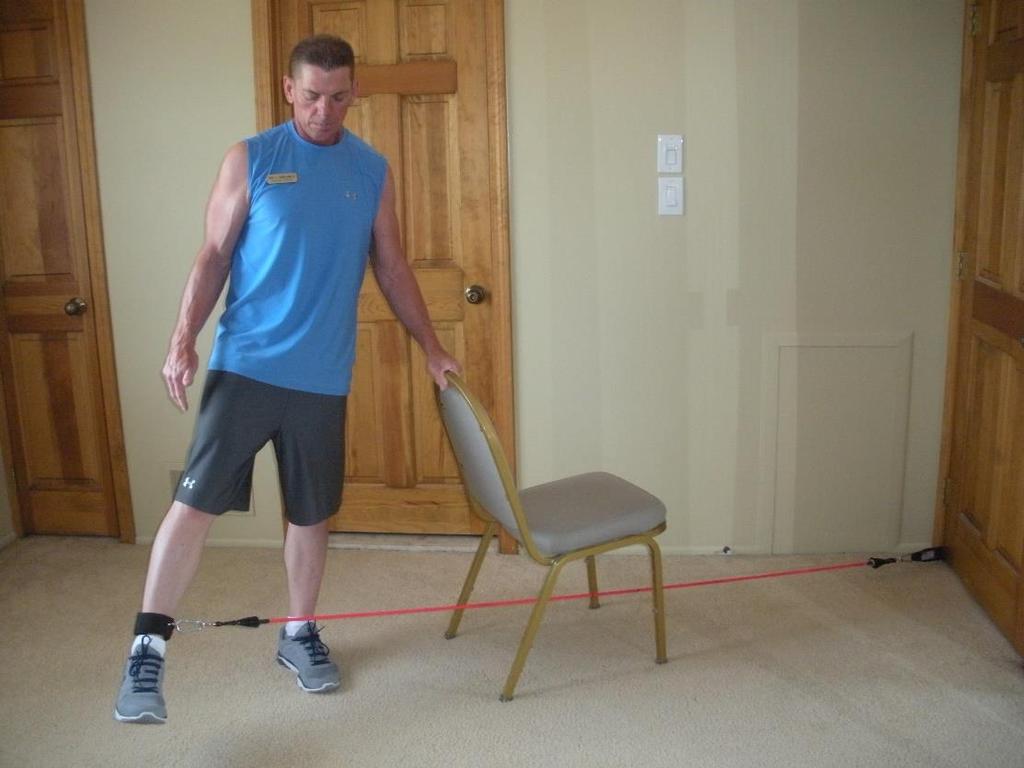 Outer Thigh Abduction Use a stable chair for balance Stand far enough from the door to feel tension in the band.