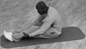Safe and Easy Stretches (continued) q Sitting Toe Touch 1. Sit on the floor with your feet placed flat against a wall, knees slightly bent.