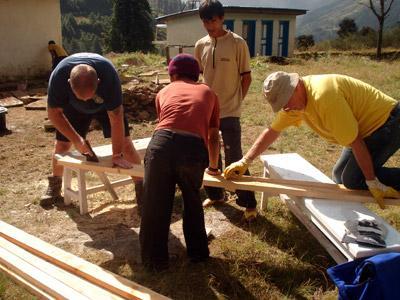 Volunteers assist local carpenter in making