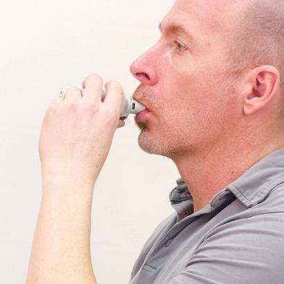 Close lips around the mouthpiece without covering the air vents. Point the inhaler towards the back of throat.