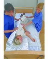 Moving the patient: up in bed Up in bed using the pull sheet/lifter (2 nurses): Do not lift, always slide.