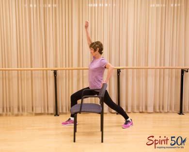 Warrior One: This is a yoga pose that has been modified by adding a chair in front for extra balance support.