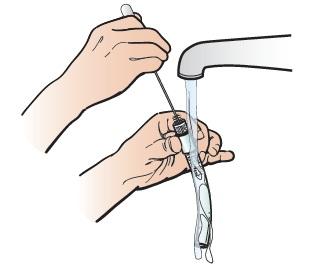 Fig ure 3. Unlocking the inner cannula 5. Hold the inner cannula under warm running water. Clean it with the nylon brush (see Figure 4). Once the cannula is clean, shake out the excess water. 6.