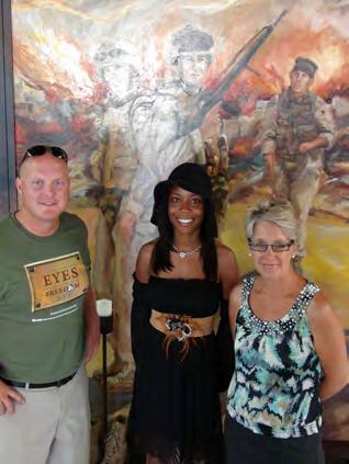 Monaye with Mike Strahl and Anita Miller in front of one of Anita s life-size