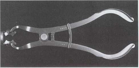 Materials & instruments of the rubber dam Retainer Forceps, both for placement and