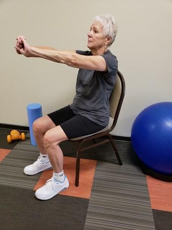 Use your opposite hand to gently push your elbow backward. Repeat with opposite arm.