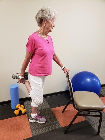 Hold on to a chair, wall or table for support. Bend your knee, lifting your heel toward your buttocks. Hold your heel in your hand to increase the stretch in the front of your thigh.
