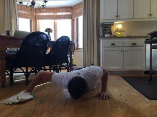 Get in a pushup position with one hand on the elevation tool, creating an uneven ground 3.