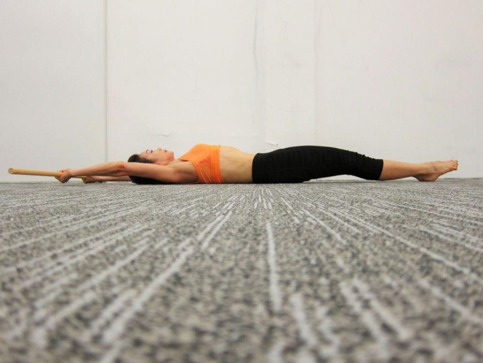 5. Supine floor handstand flexion with dowel Activate Core muscles Supine flat on floor with legs together and straight, arms overhead while holding dowel at shoulder width apart [Photo 5A].
