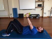Maintaining forearm contact with the wall slide your arms up the wall, return to the start position and repeat.