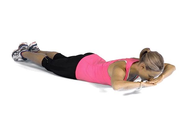 Lower Back Extension Lie on the floor on your back with arms bent and legs lengthened on the floor.