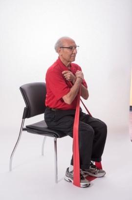 Stand with your feet hip-distance apart or sit in a chair with a straight back. Do not slouch in the chair. Place the band under the left foot. Start with moderate tension on band.