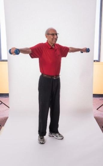 FRONT SHOULDER RAISE - BAND Stand with your feet hip-distance apart or sit in a chair with a straight back. Do not slouch in the chair. Place the band under your right foot.